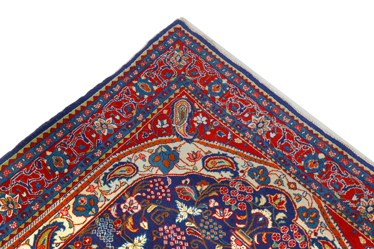 Close-up of Sarouk rug corner with intricate floral motifs and richly patterned border