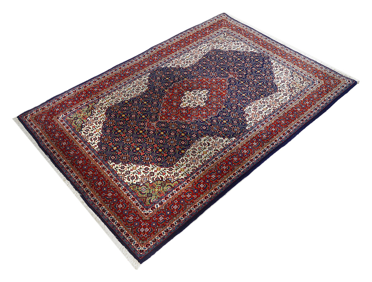 Full Persian Sarouk rug showing central medallion and richly decorated geometric borders
