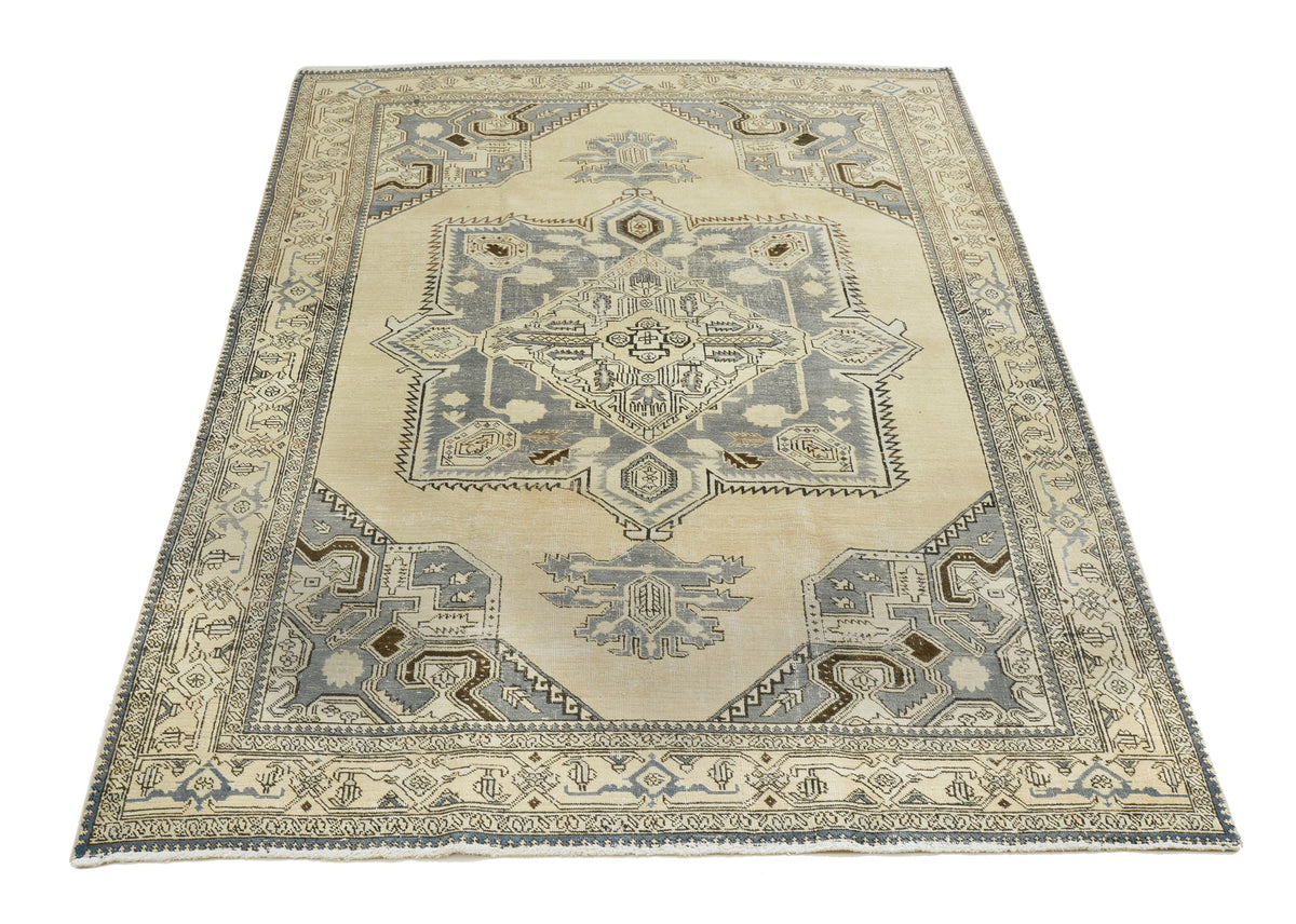 Full view of vintage Persian Tabriz carpet with central medallion and decorative borders
