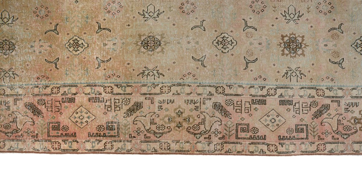 Detailed Tabriz carpet border featuring intricate geometric and floral patterns in muted tones
