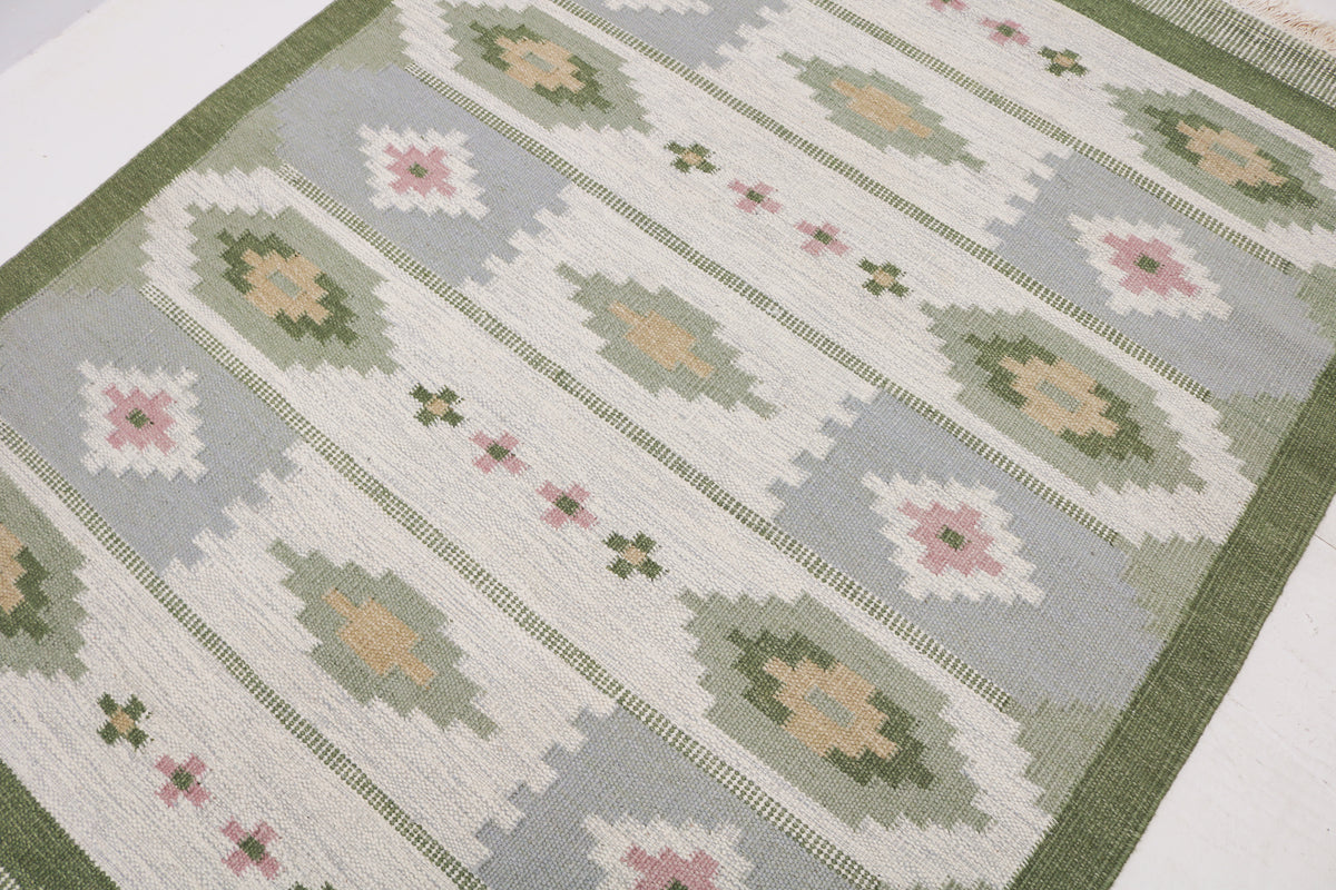 Detailed view of Swedish Kilim rug with repeating geometric motifs and soft muted colours