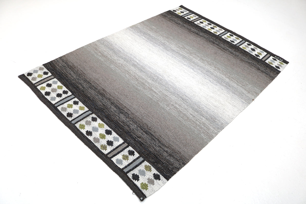 Angled view of Swedish Kilim featuring subtle gradient tones and patterned borders