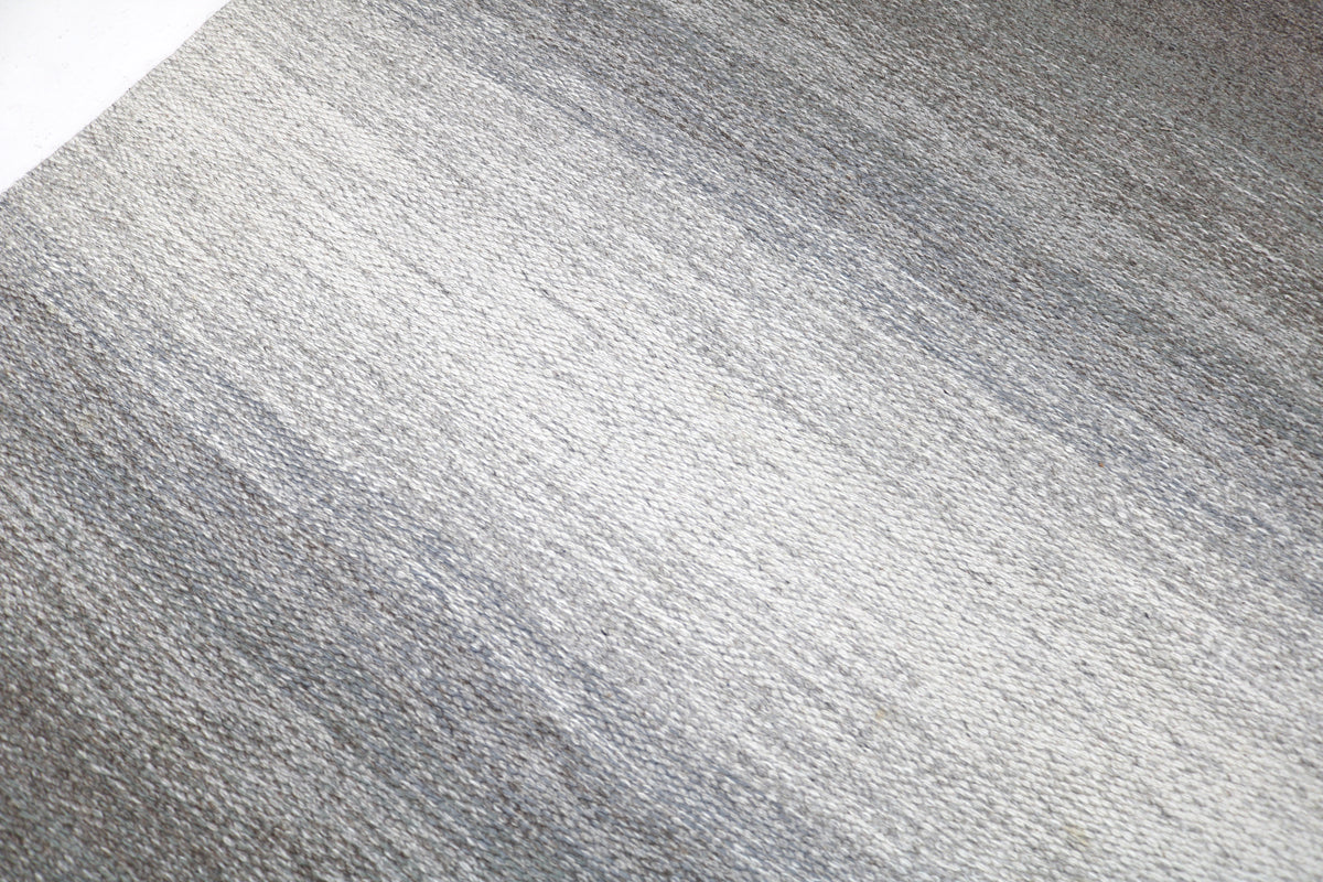 Close-up of muted grey Kilim field with subtle woven texture