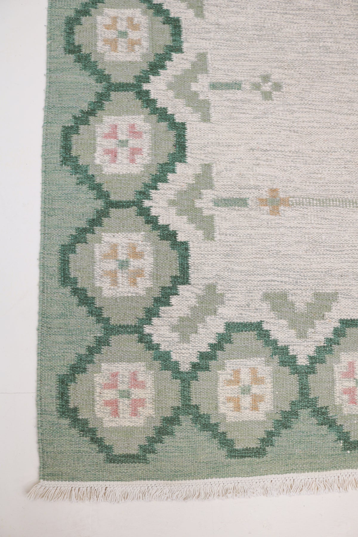 Vintage Swedish Kilim rug with pale grey field and geometric floral border in sage green