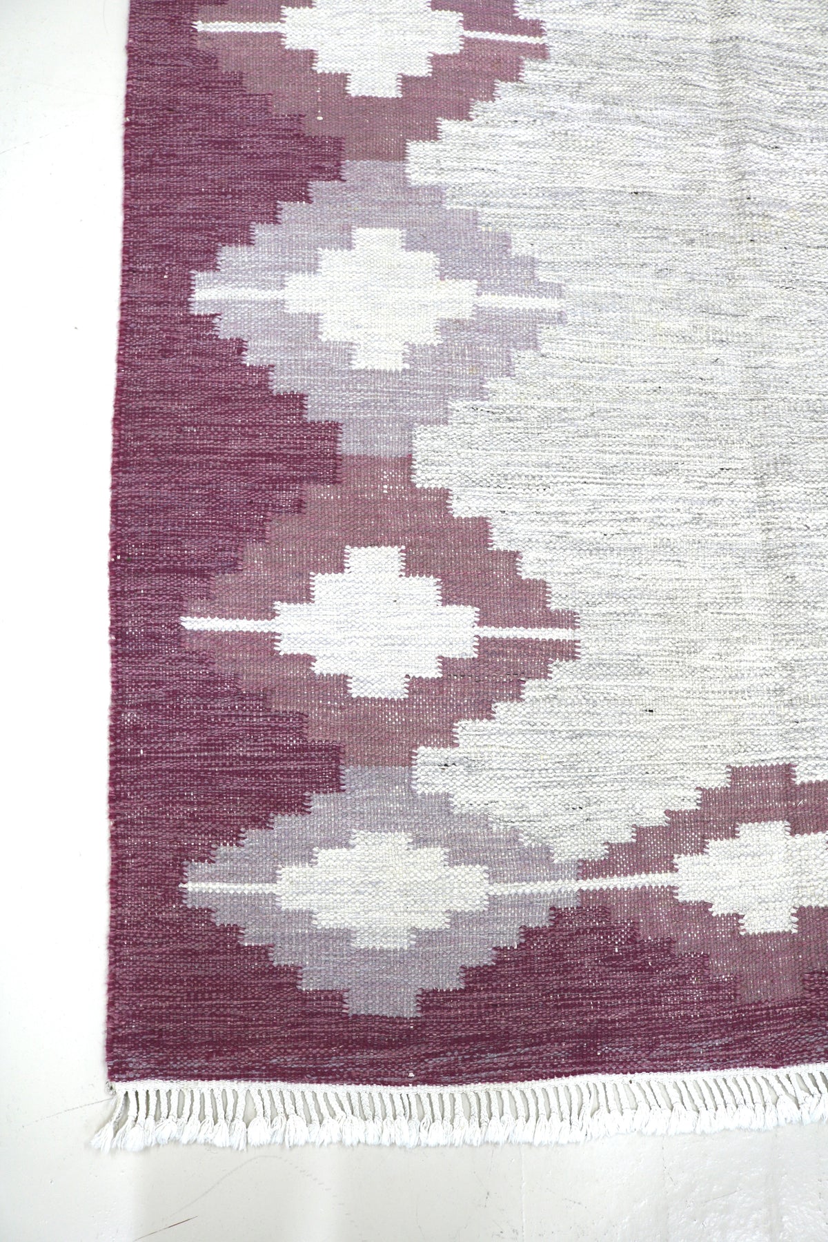 Vintage Swedish Kilim rug with burgundy field, ivory geometric motifs and soft grey tones
