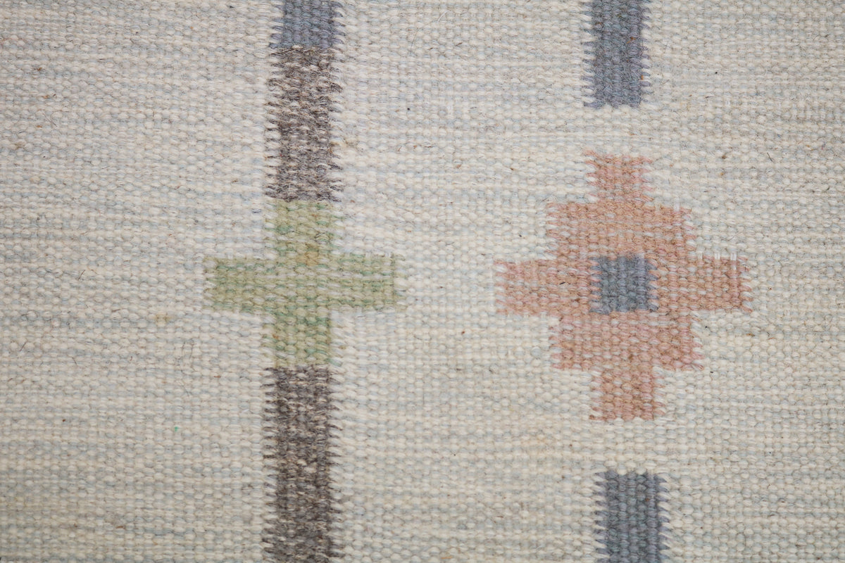 Detailed vintage Swedish Kilim rug surface with soft geometric motifs and natural woven texture