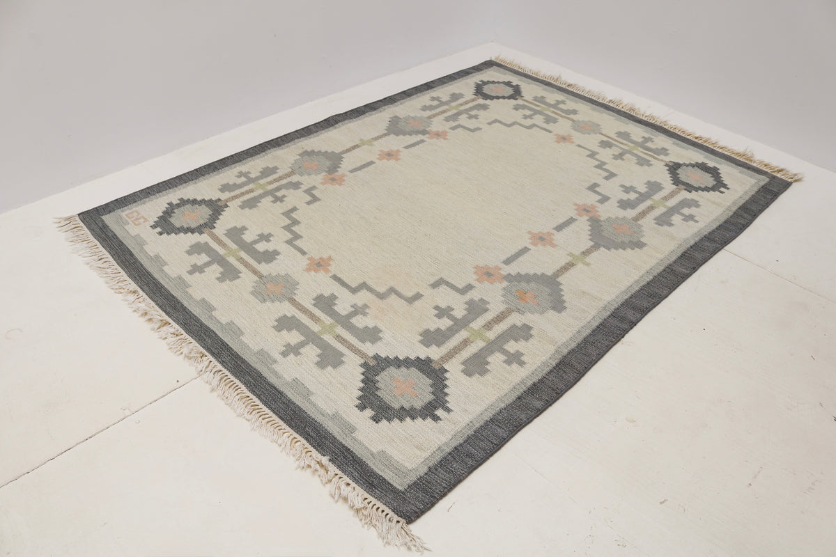 Vintage Swedish Kilim rug showcasing a spacious ivory field with delicate geometric patterns