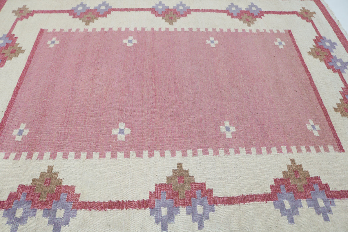Vintage Swedish Kilim rug detail featuring repeating floral motifs along the decorative border