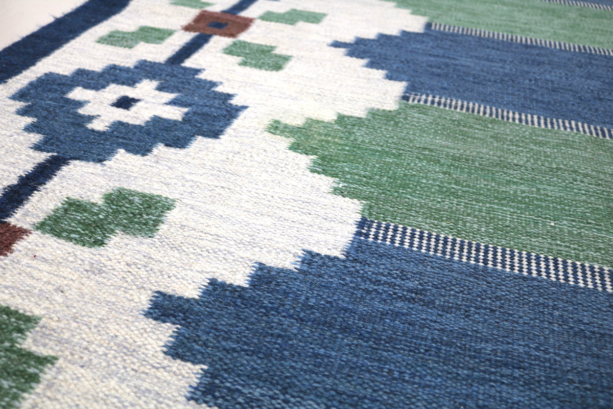 Detailed Swedish Kilim rug with floral motifs, geometric shapes and soft Scandinavian colours

