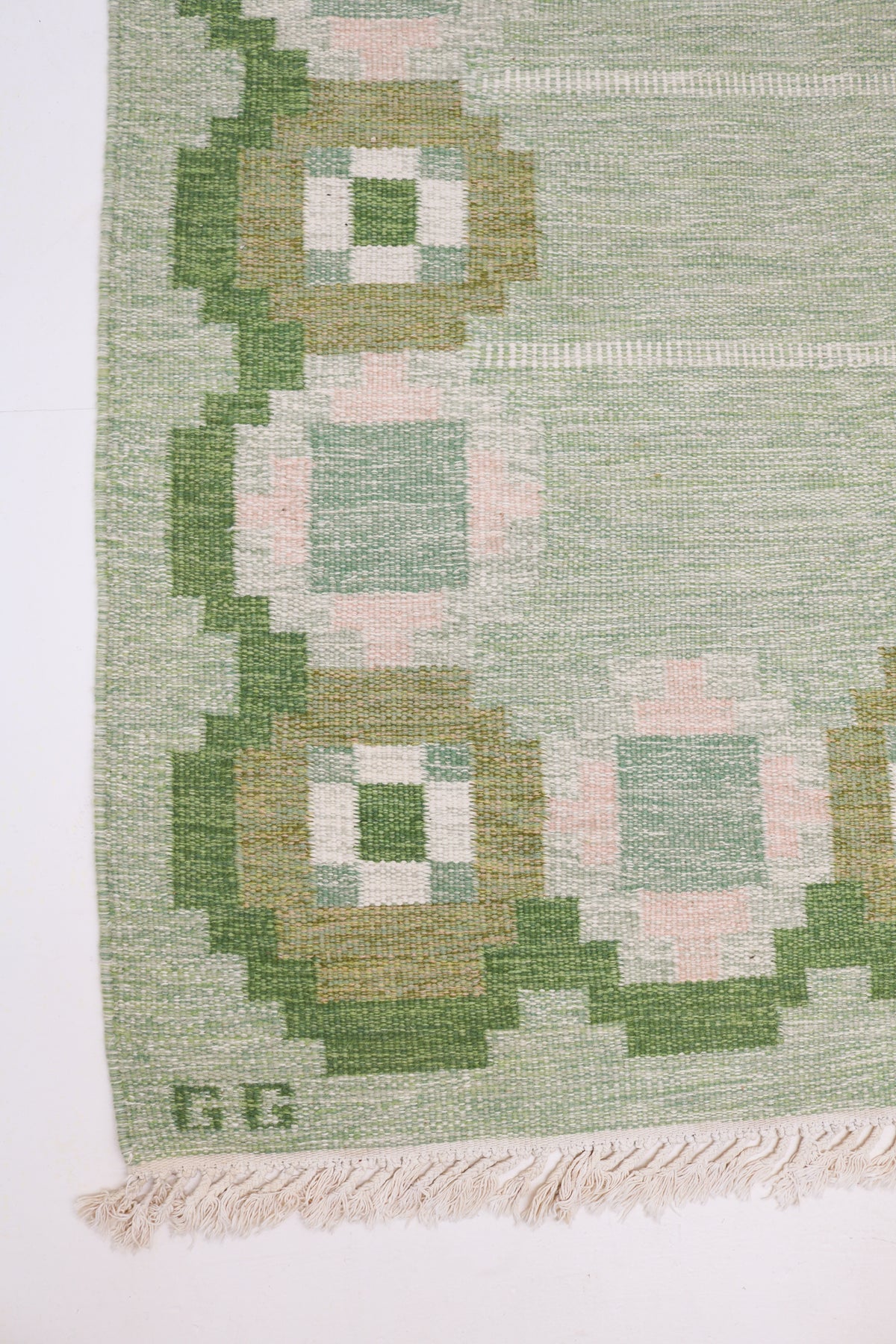 Vintage Swedish Kilim rug with soft green field and geometric border in olive, ivory and pale pink
