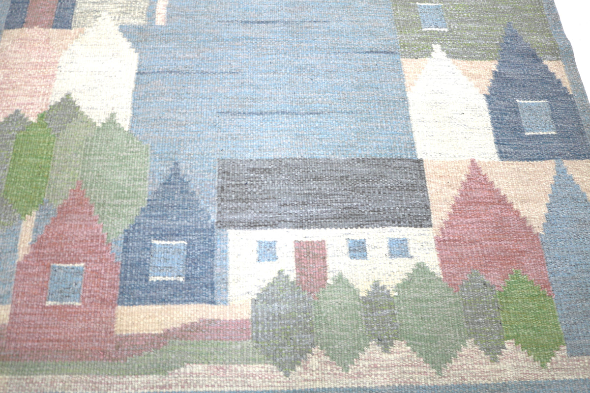 Close-up of village scene with stylised houses, trees and muted Scandinavian colours