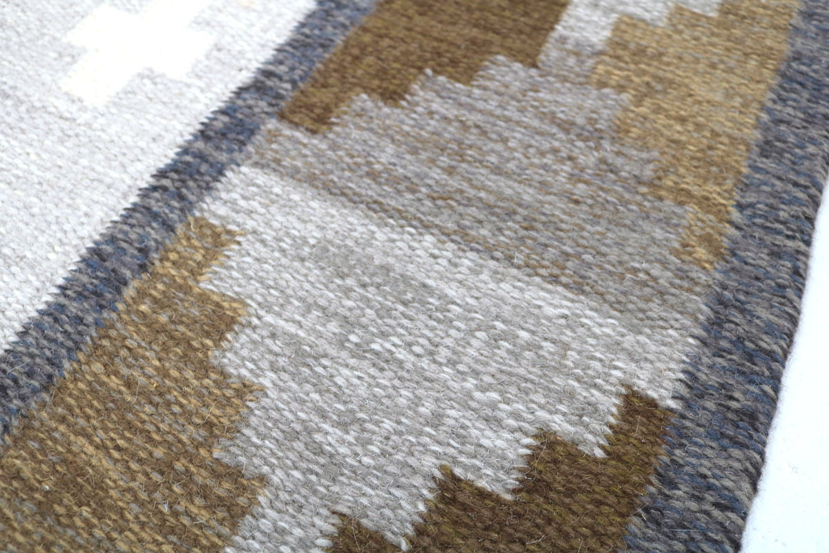 Detailed view of Swedish Kilim rug with repeating diamond patterns in neutral earthy tones
