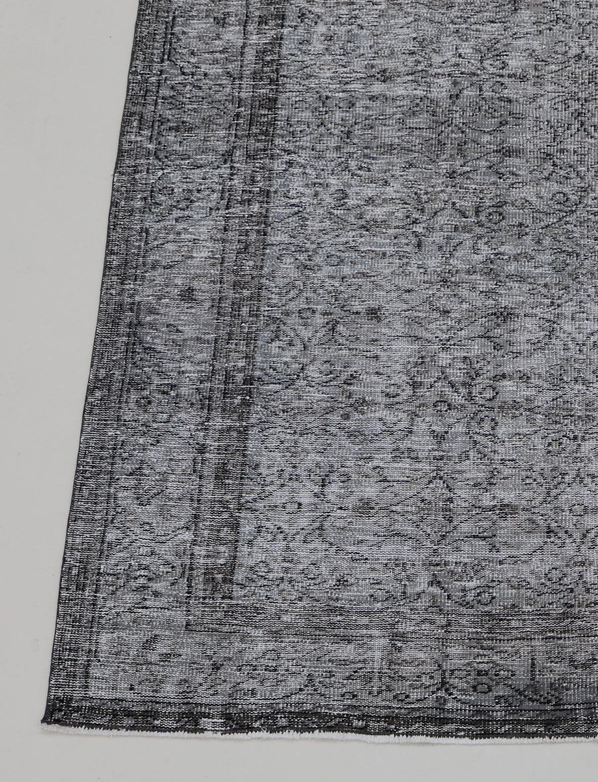 Vintage Turkish Sparta rug with grey field, subtle floral motifs and dark decorative border
