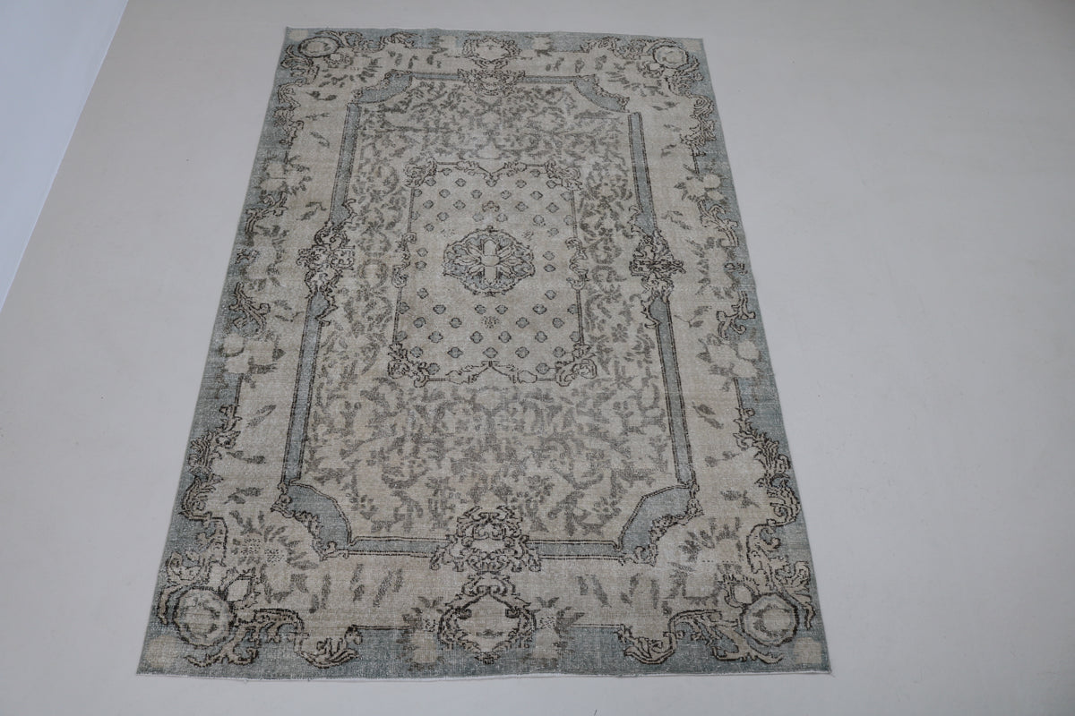 Full view of vintage Turkish Sparta rug with subtle floral design and muted neutral tones
