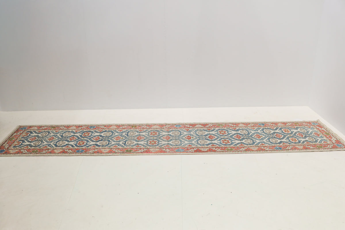 Vintage Ushak runner displaying a long narrow design with ivory, blue and coral tones