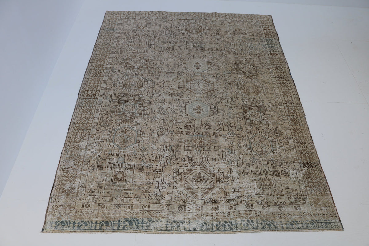 Faded antique Persian Heriz rug in soft sand, brown and grey-blue