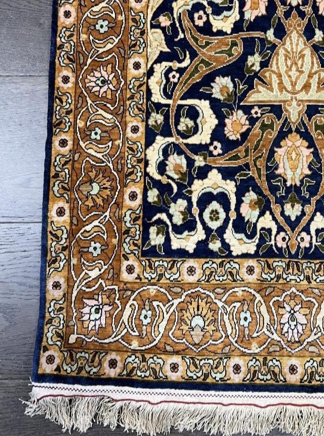 Vintage Hereke silk prayer rug with deep blue field, gold accents and ornate floral motifs