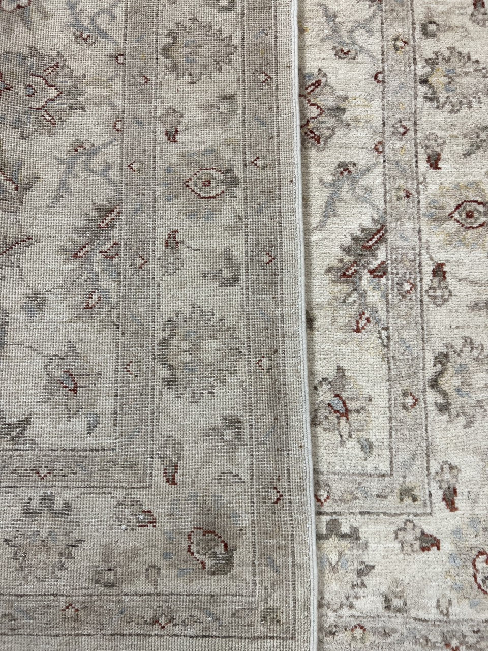 Side view of Ziegler rug showing floral field and contrasting patterned borders