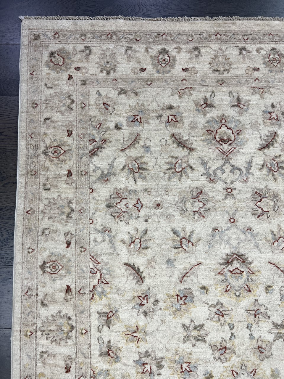 Close-up of Ziegler rug featuring subtle floral motifs in beige and muted tones