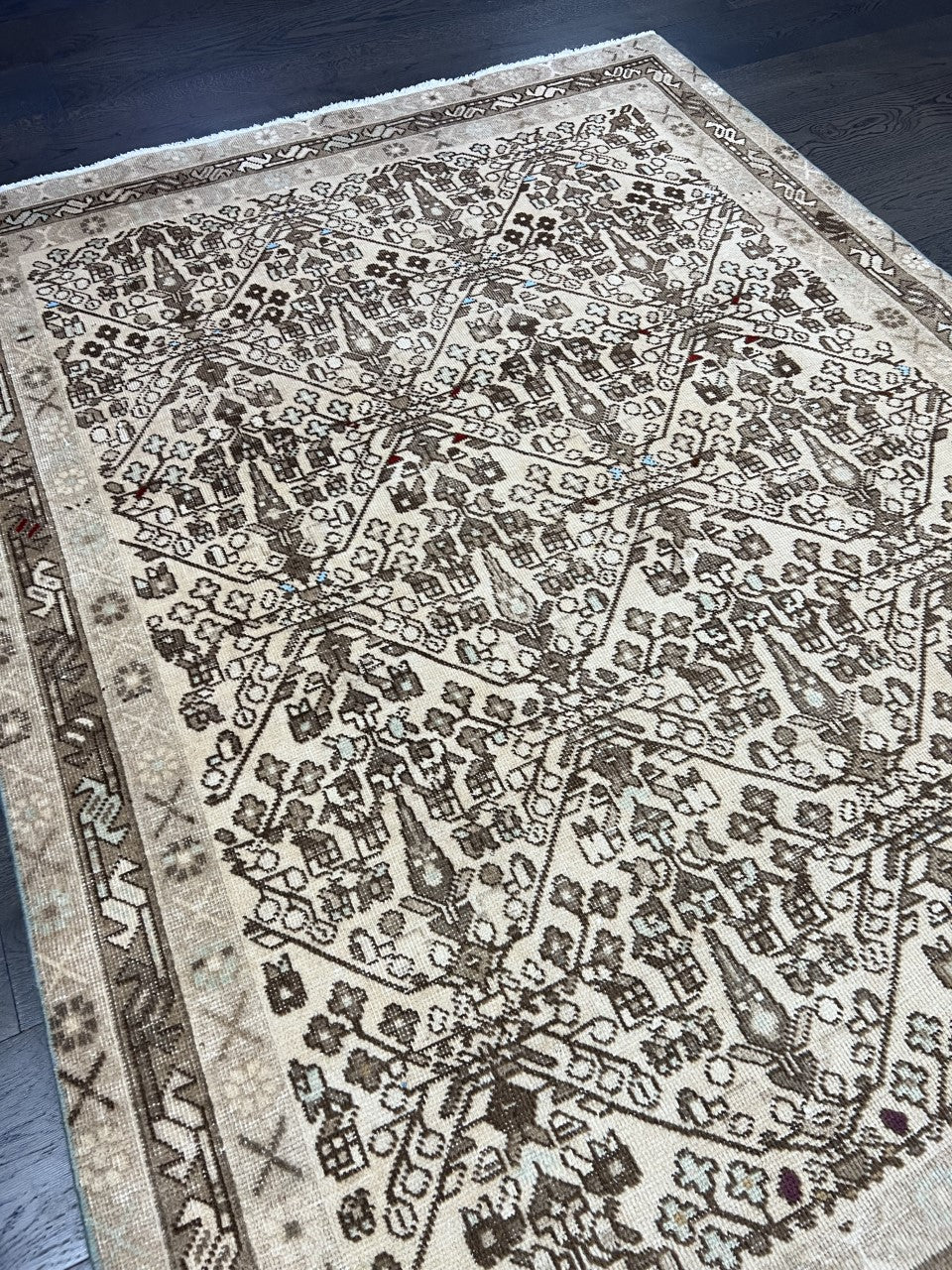 Detailed geometric rug pattern with earthy brown, beige and muted grey tones