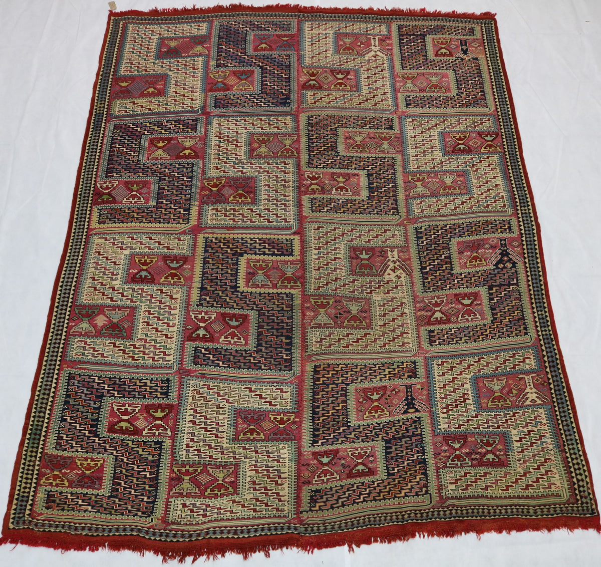 Full Caucasian Zilleh rug showing repeating geometric panels and rhythmic patterns
