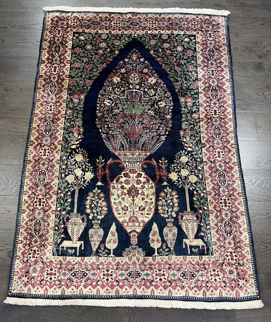 Full Kaisary prayer rug showing blue prayer niche framed by intricate decorative borders