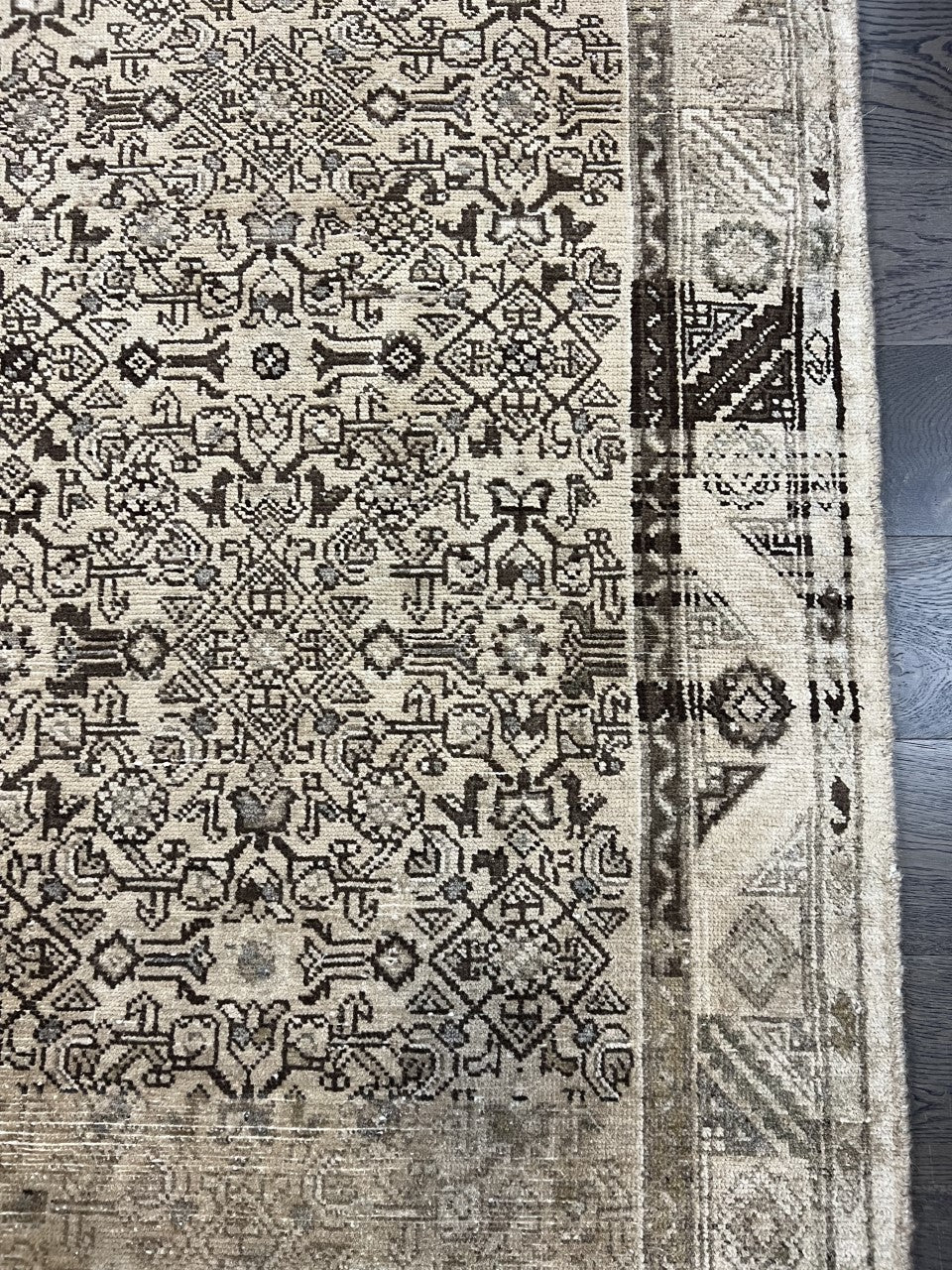 Detailed Malayer rug section with repeating floral motifs and geometric patterns