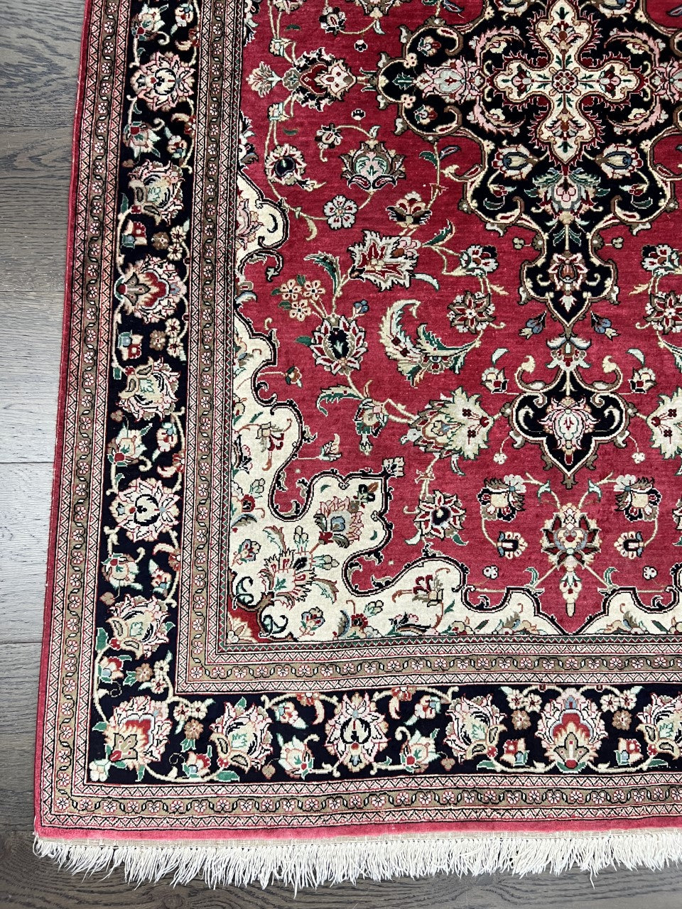Vintage Persian Isfahan silk rug with red field, black medallion and ornate floral border