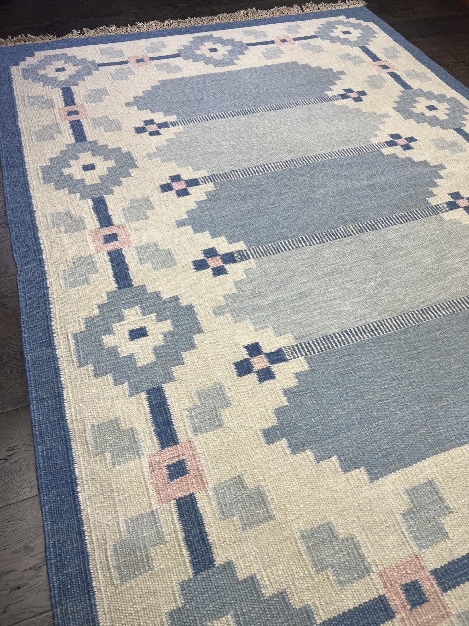 Angled view highlighting the flat-woven texture and balanced geometric composition