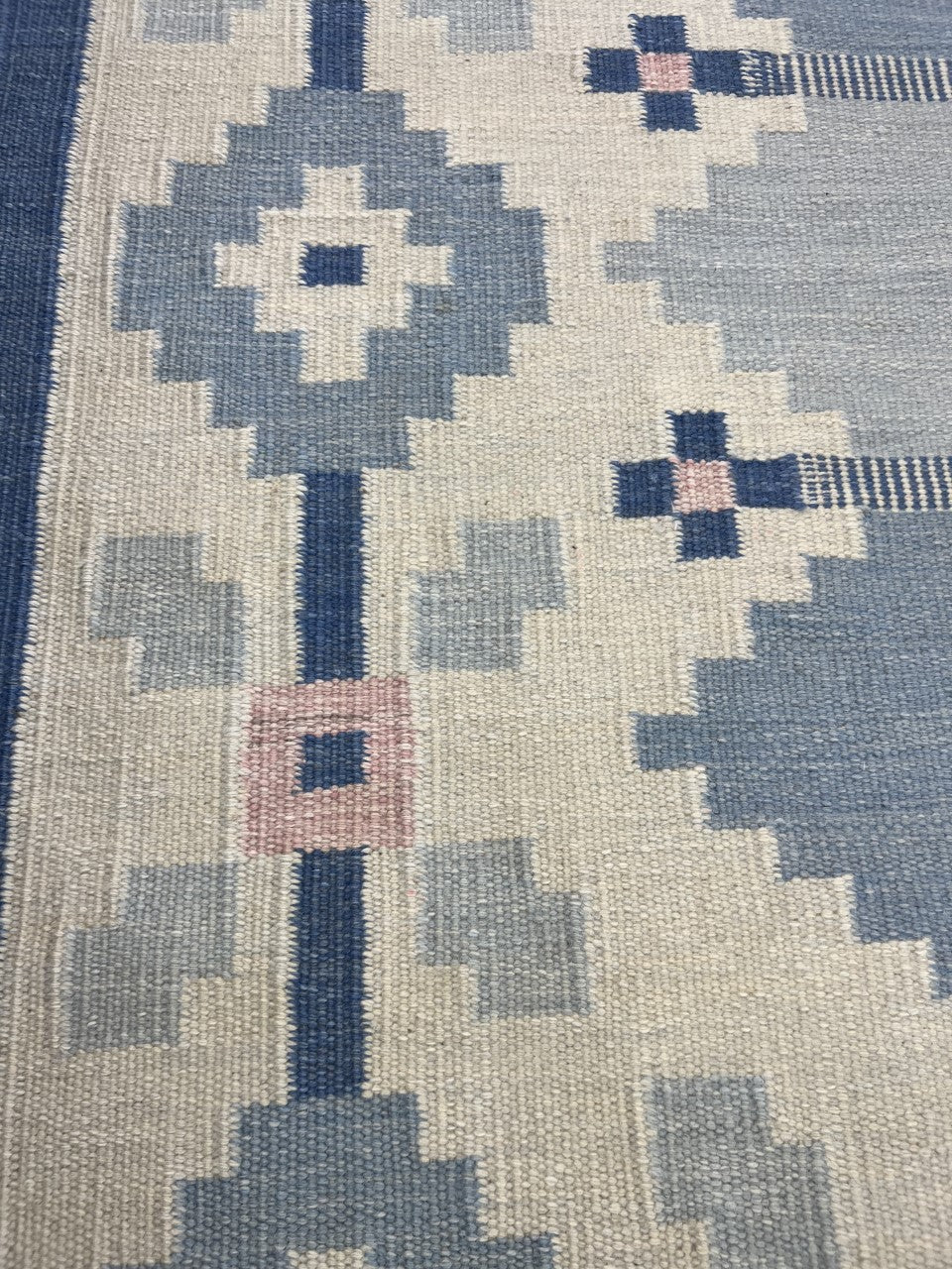 Detailed Swedish Kilim field with diamond motifs and soft blue tonal variations